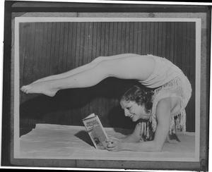 Gertrude Fisher takes unusual position to read the latest novel of her husband M.S. Merritt
